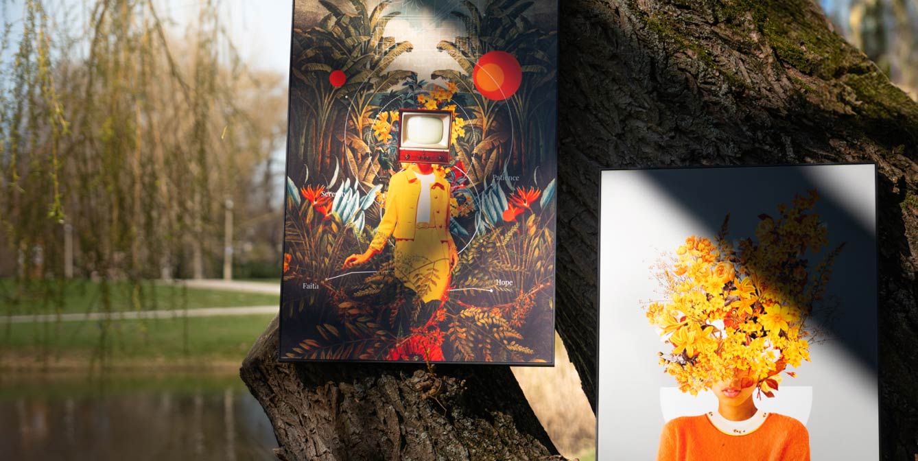 Two surrealist artworks hanging on a tree in the park – left: a figure with a TV head in a tropical setting, right: a portrait with yellow flowers instead of a face